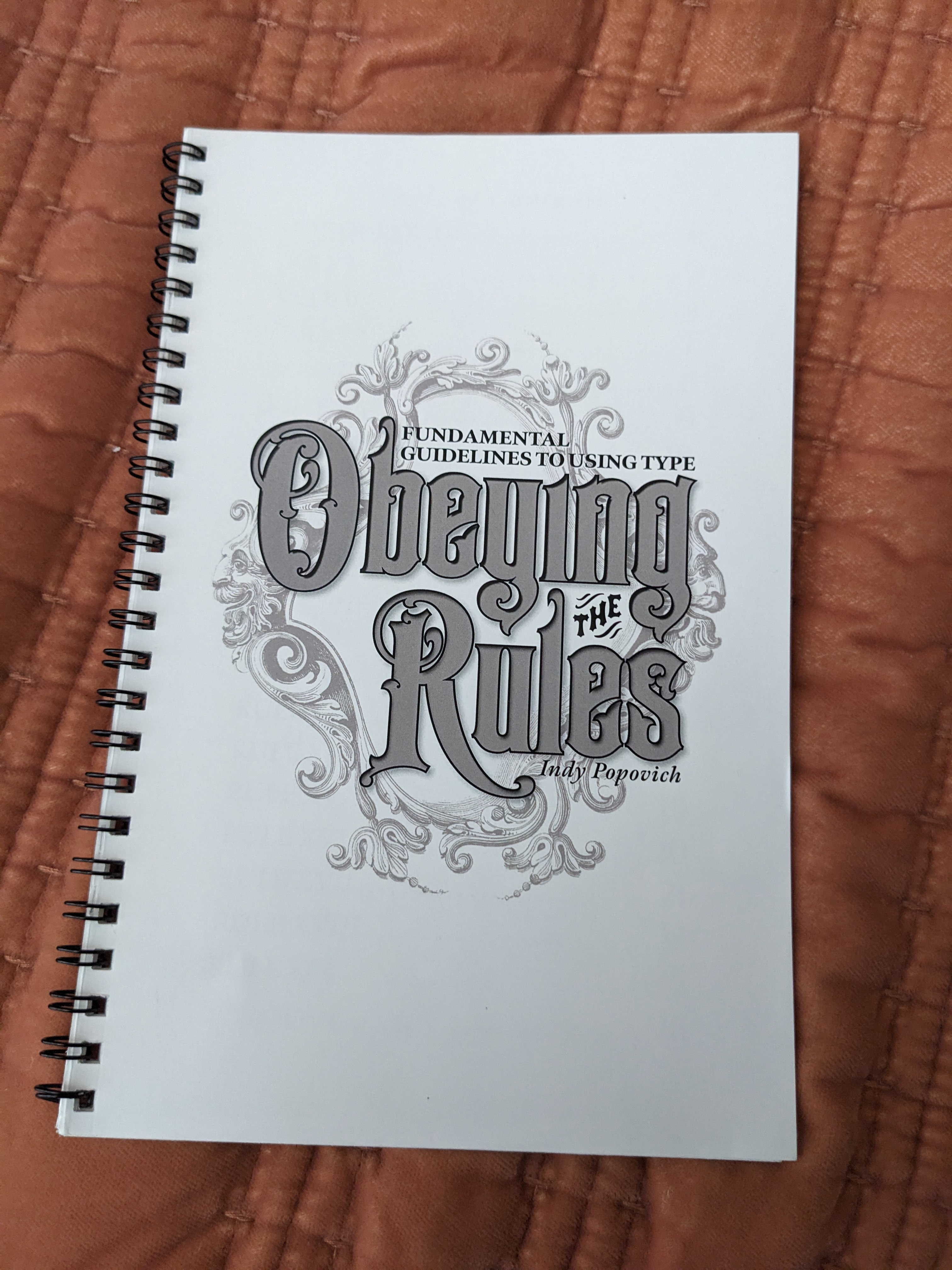 Booklet cover with 19th century style lettering and ornaments reading 'Obeying the Rules: Fundamental Guidelines to Using Type'